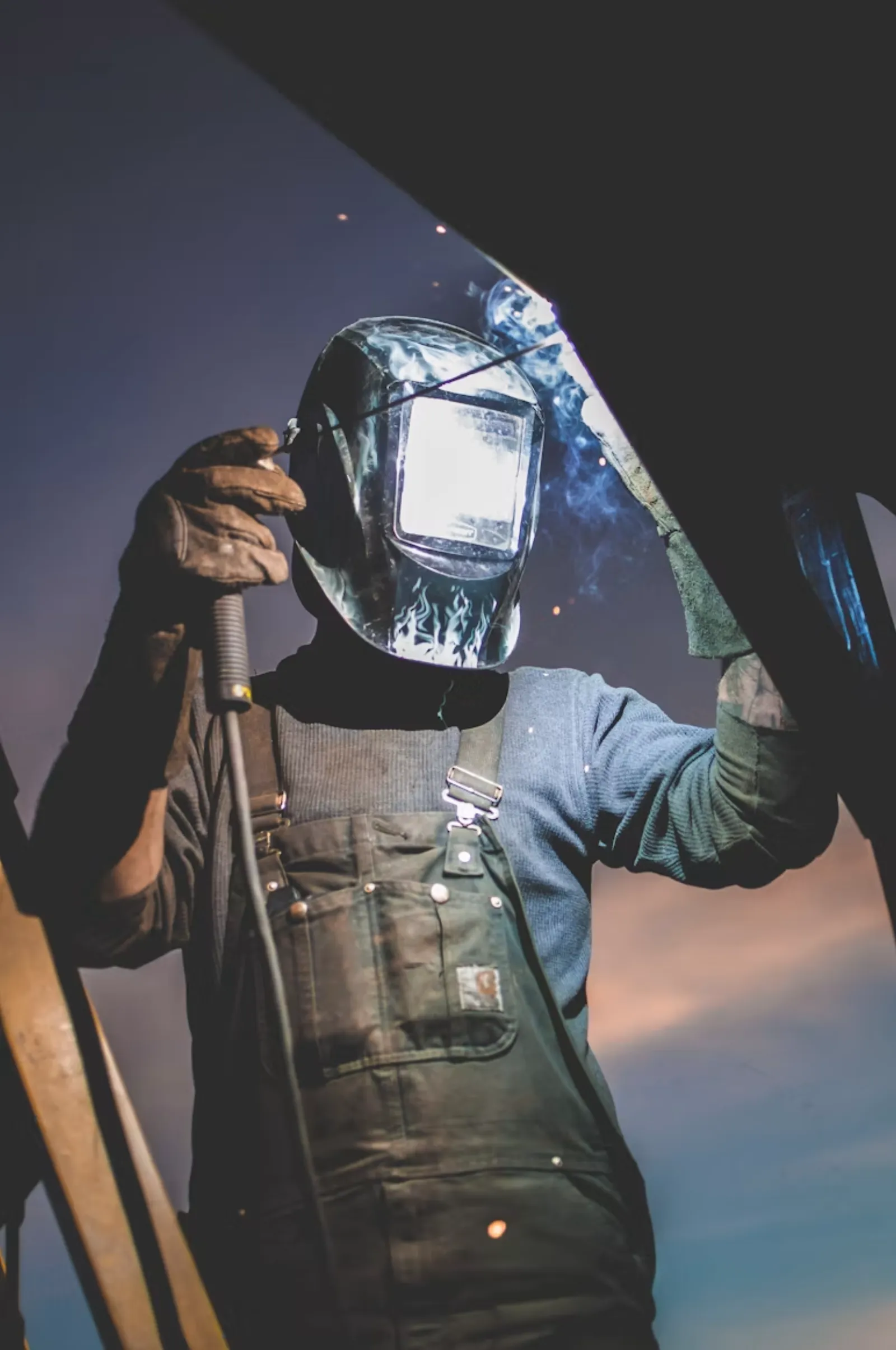 A tradesperson welding on a construction site